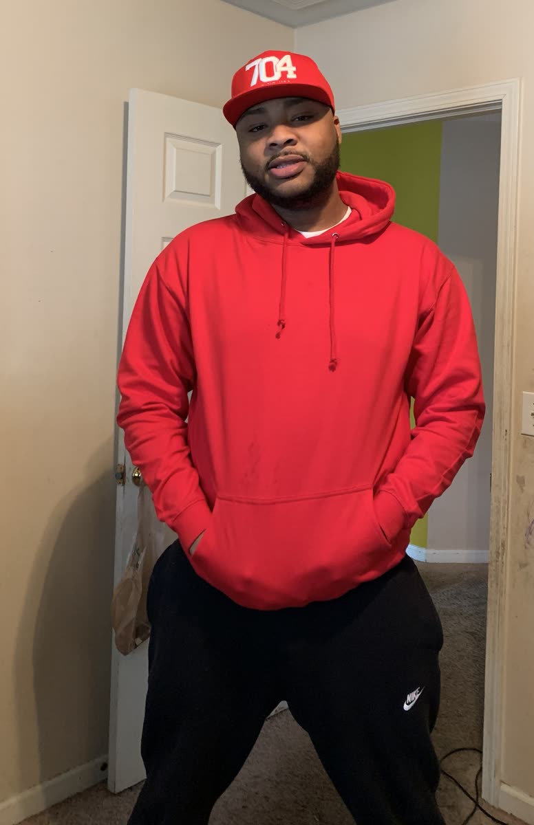 Scottie Stowe in a red hoodie and 704 cap